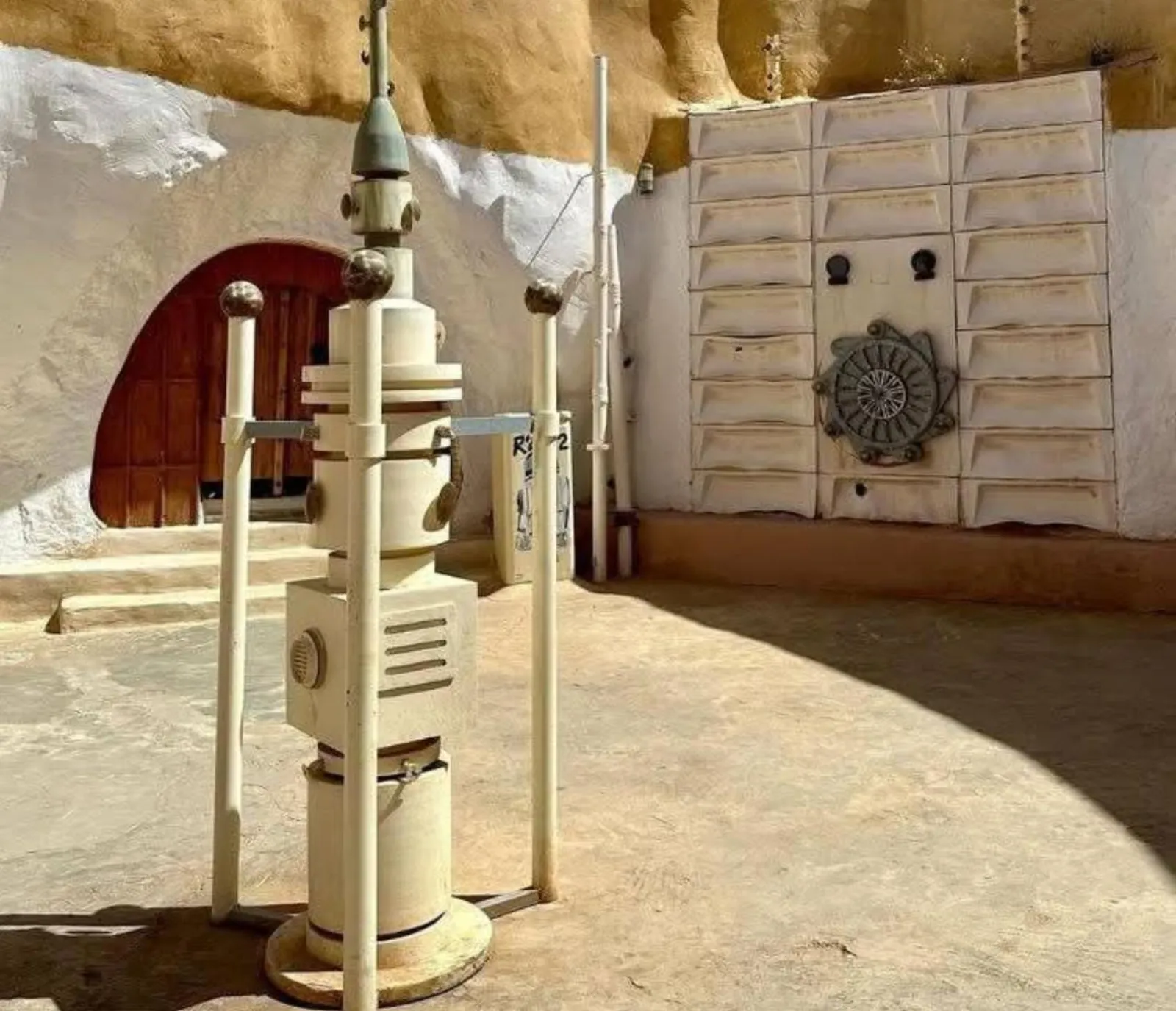 The sunken courtyard of Sidi Driss in Matmata, with a moisture-vaporator prop and an R2-D2 marker