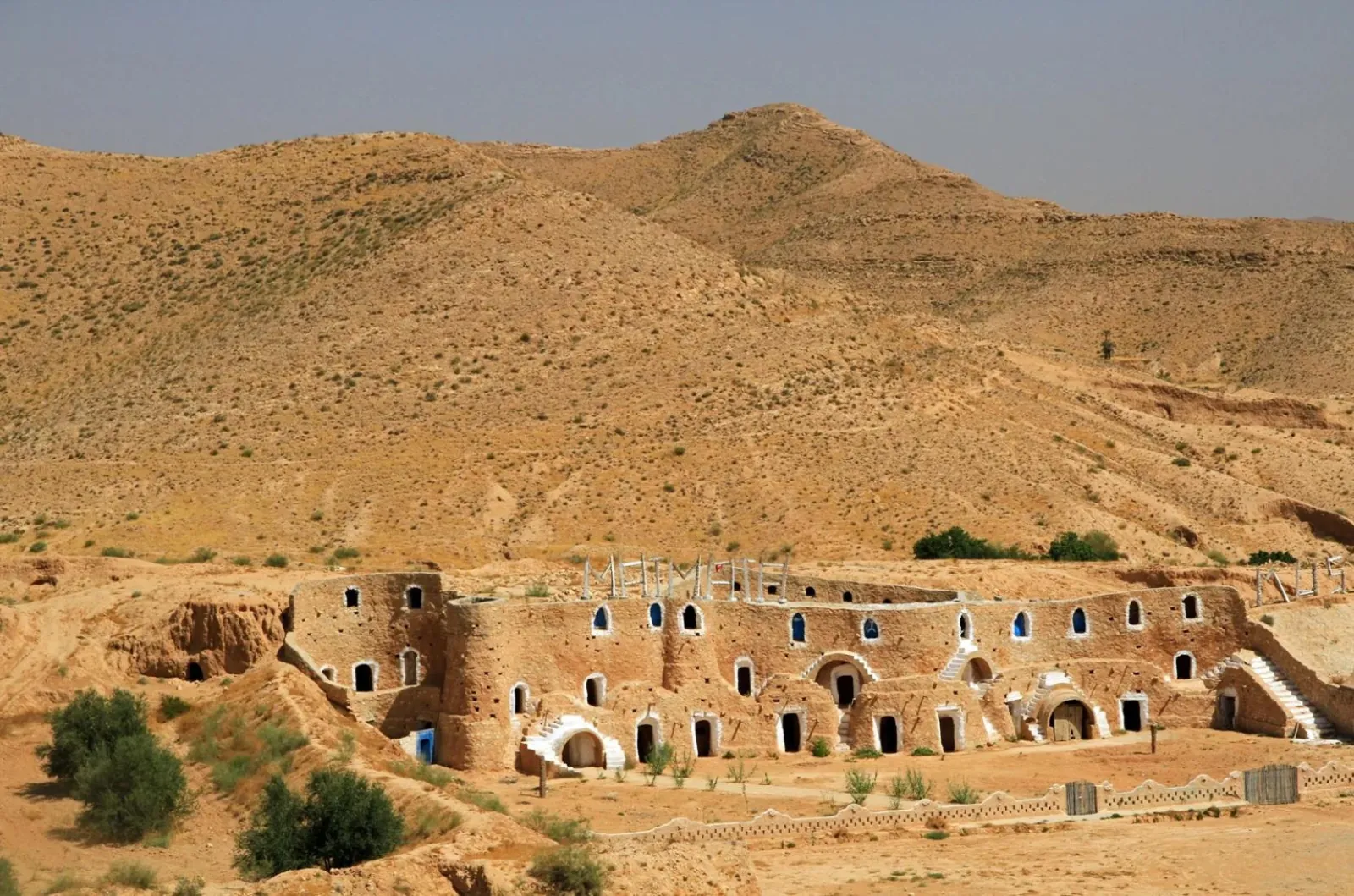 The troglodyte houses of Matmata dug into the hillside below a bare ridge