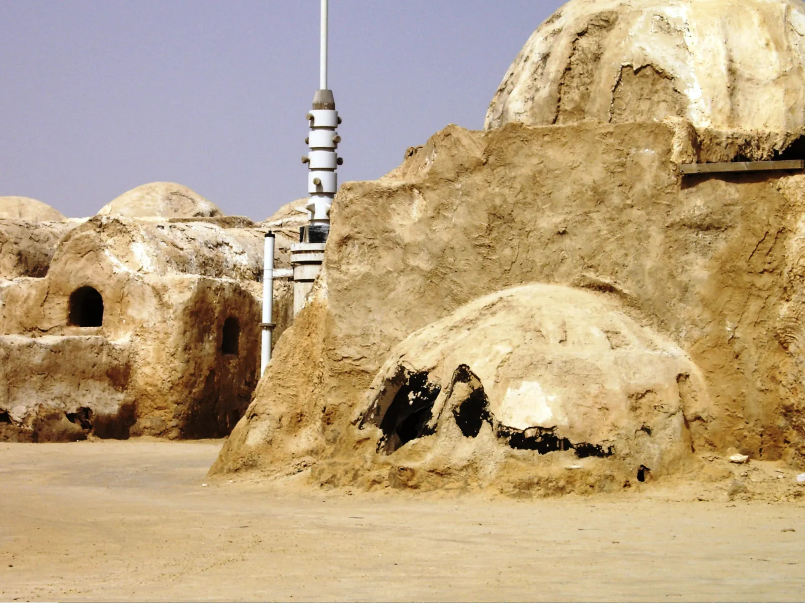 Close view of Mos Espa's domed buildings and a white moisture vaporator