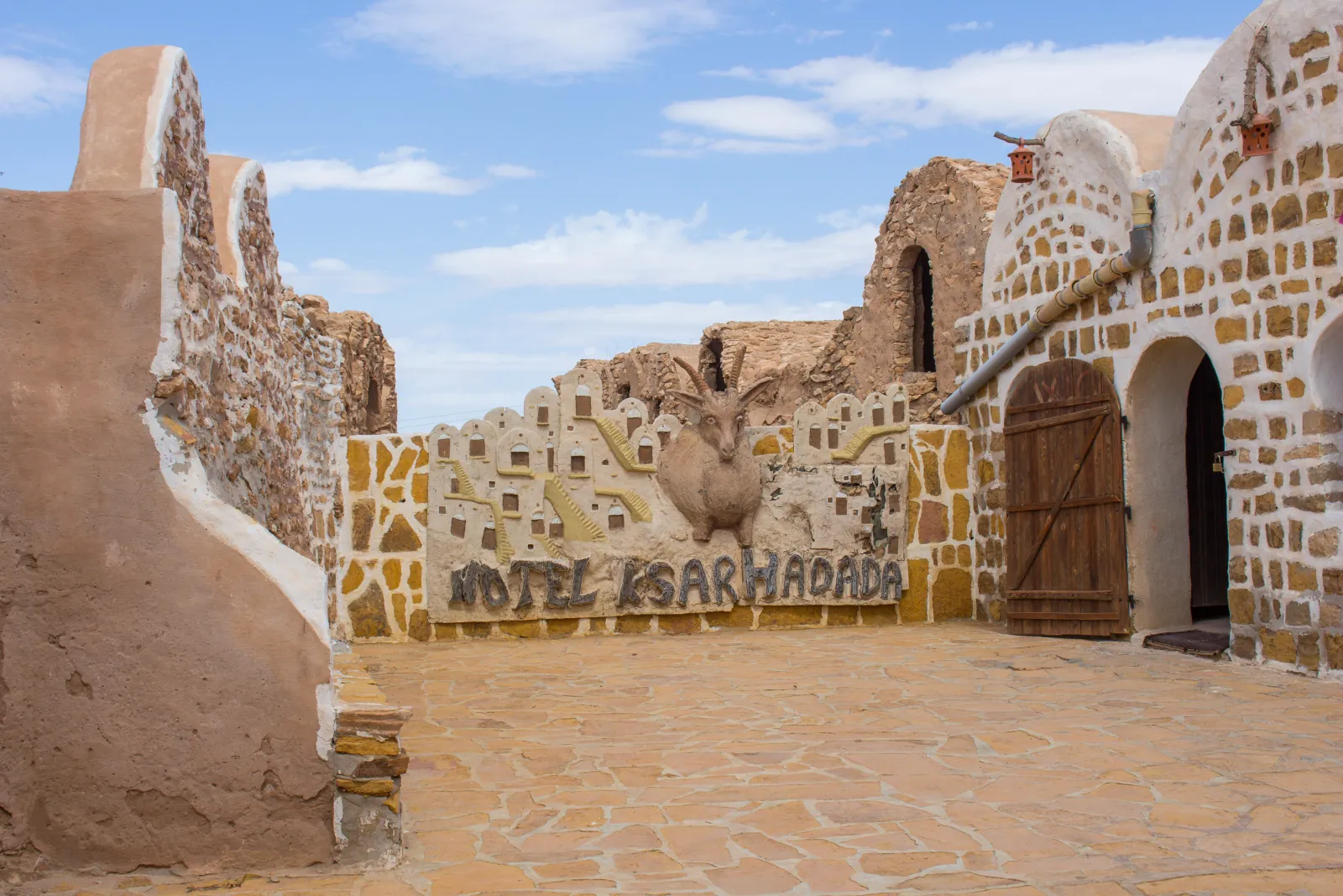 The courtyard gate of Ksar Hadada, with its ibex sculpture and modelled ksar frieze