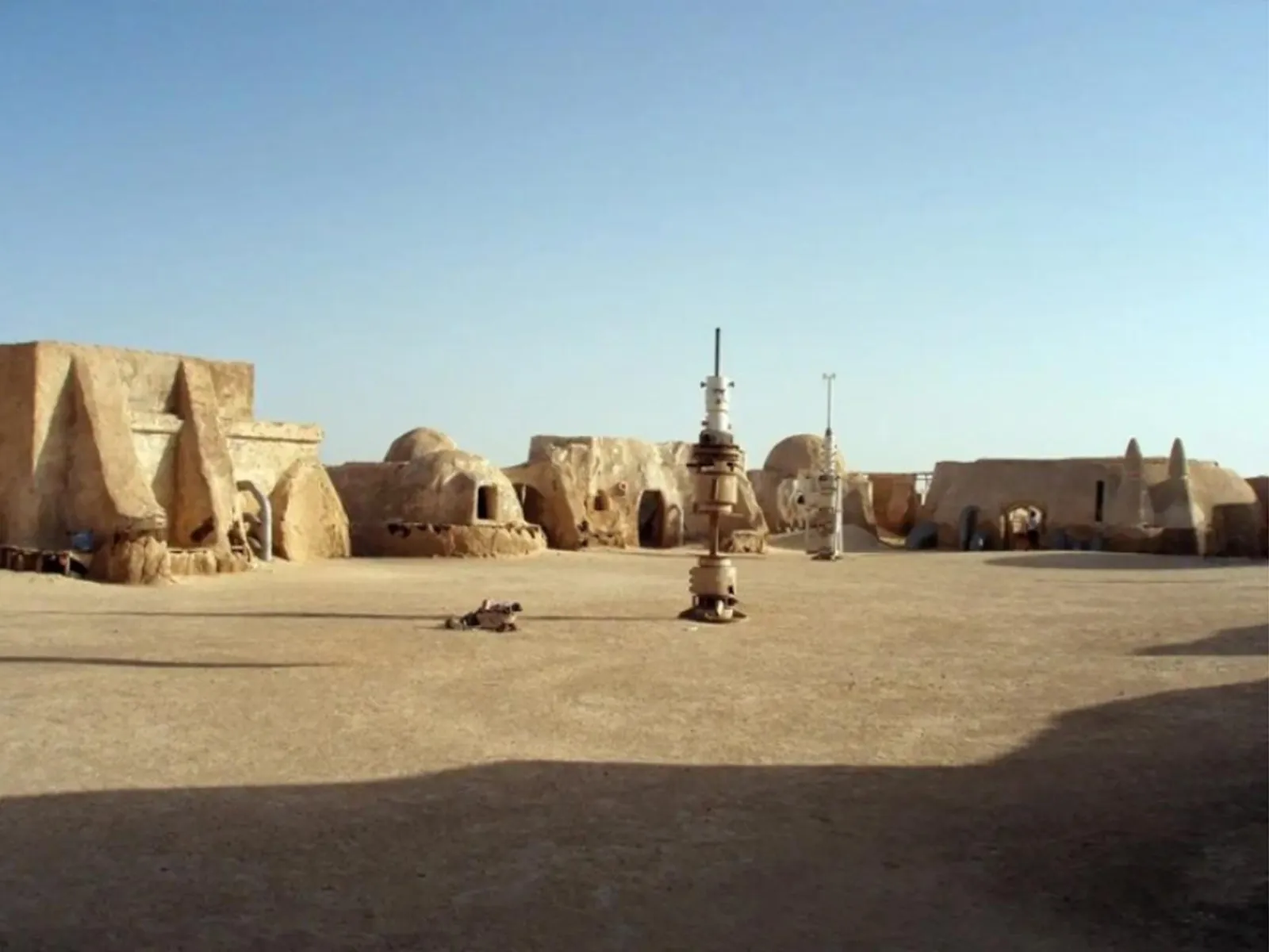 The full width of the Mos Espa street, domed buildings and a vaporator on the sand