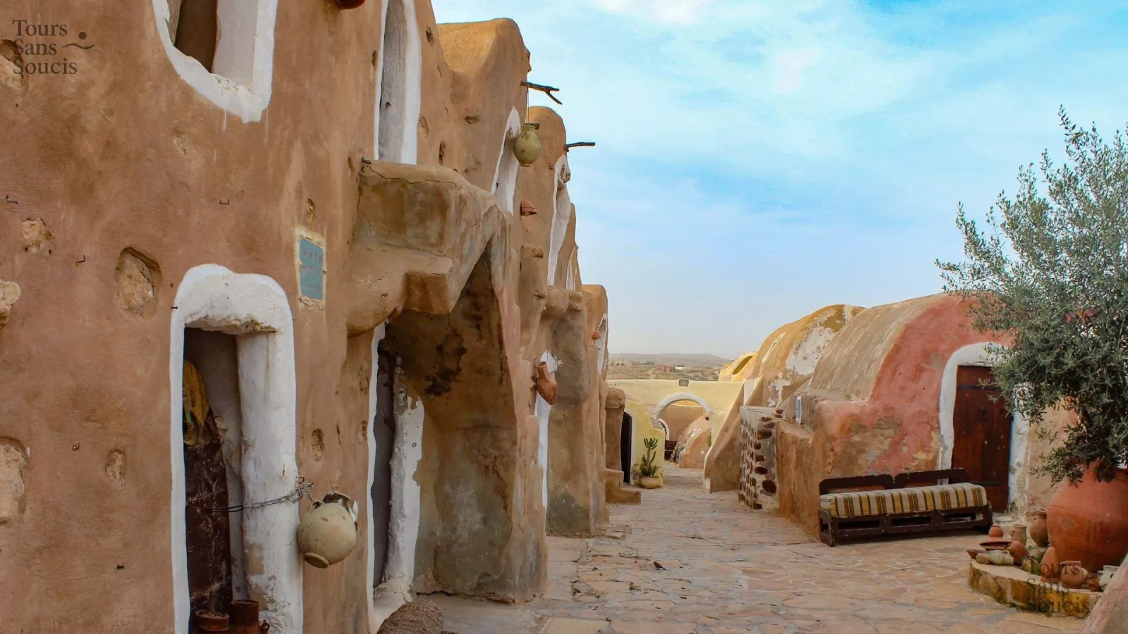 The paved lane through Ksar Hadada, hung with pottery and lined with domed cells